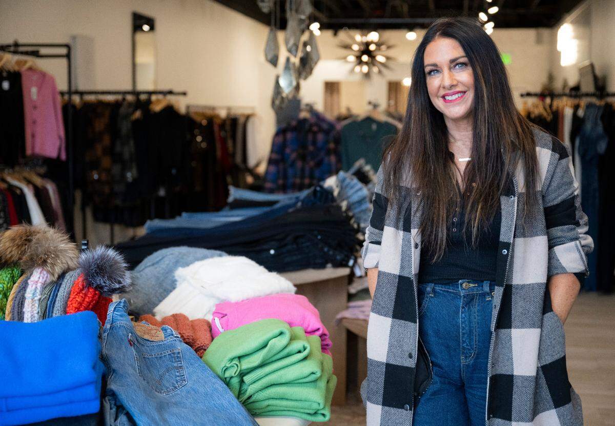 R Storie owner Rachel Peirce poses for a portrait inside of her women’s clothing boutique on Nov. 30, 2022 in Gig Harbor. Peirce opened her shop in October 2022 after working for Nordstrom for over 20 years.