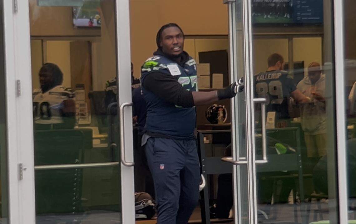 Starting left tackle Charles Cross comes out of the training room and the Seattle Seahawks’ Virginia Mason Athletic Center into the rain to practice Wednesday, Jan. 7, 2026, for the first time since he injured his hamstring three weeks earlier.