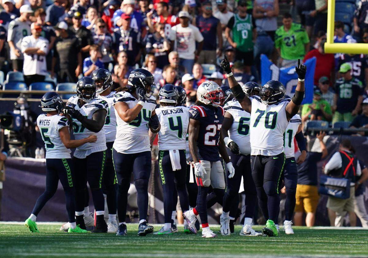 Sep 15, 2024; Foxborough, Massachusetts, USA; Seattle Seahawks guard Laken Tomlinson (70) reacts after place kicker Jason Myers (5) kicks a field goal to win the game in overtime at Gillette Stadium. Mandatory Credit: David Butler II-Imagn Images