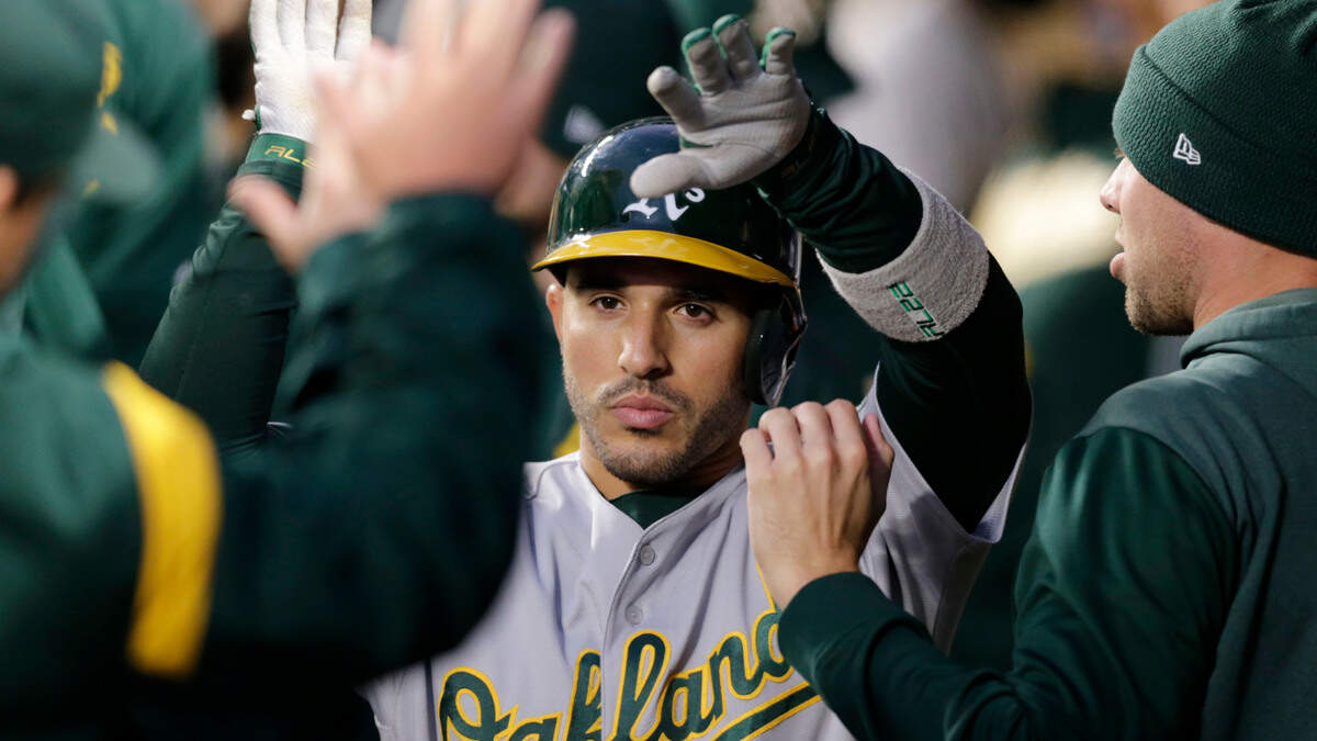 Oakland Athletics’ Ramon Laureano makes his way through the dugout after hitting a solo home run on a pitch from Seattle Mariners’ Marco Gonzales during the third inning of a baseball game, Saturday, Sept. 28, 2019, in Seattle.