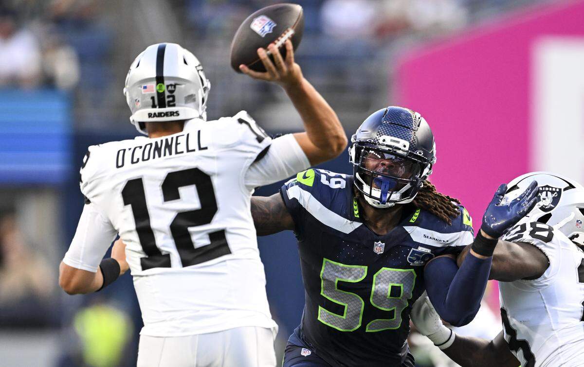 Seattle Seahawks linebacker Tyreke Smith (59) pressures Las Vegas Raiders quarterback Aidan O'Connell (12) during the second quarter of the game at Lumen Field, on Thursday, Aug. 7, 2025, in Seattle, Wash.
