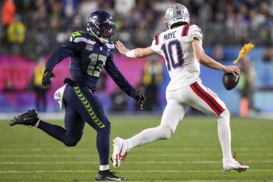 New England Patriots quarterback Drake Maye (10) attempts to scramble away from Seattle Seahawks linebacker Ernest Jones IV (13) during the third quarter of Super Bowl LX at Levi's Stadium on Feb. 8, 2026 in Santa Clara, Calif.
