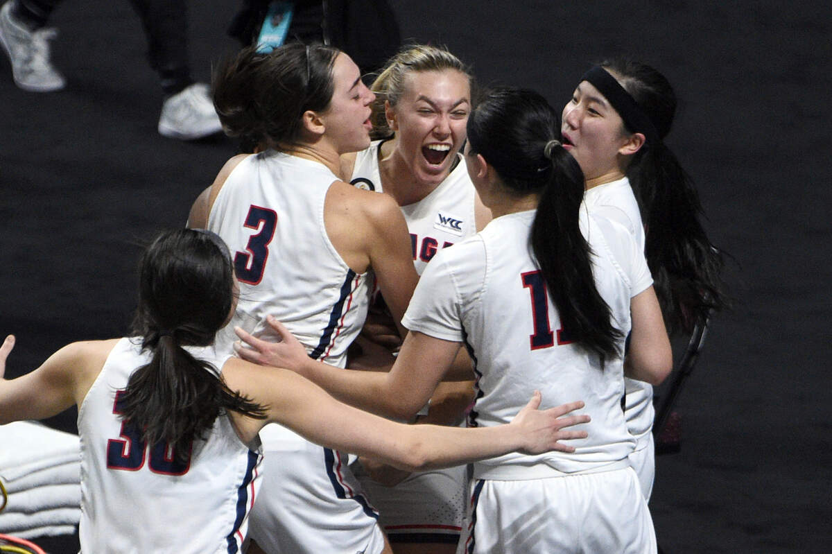 Gonzaga guard Jill Townsend, center, celebrates with teammates after scoring the winning basket against BYU in an NCAA college basketball game for the West Coast Conference women’s tournament championship Tuesday, March 9, 2021, in Las Vegas. (AP Photo/David Becker)