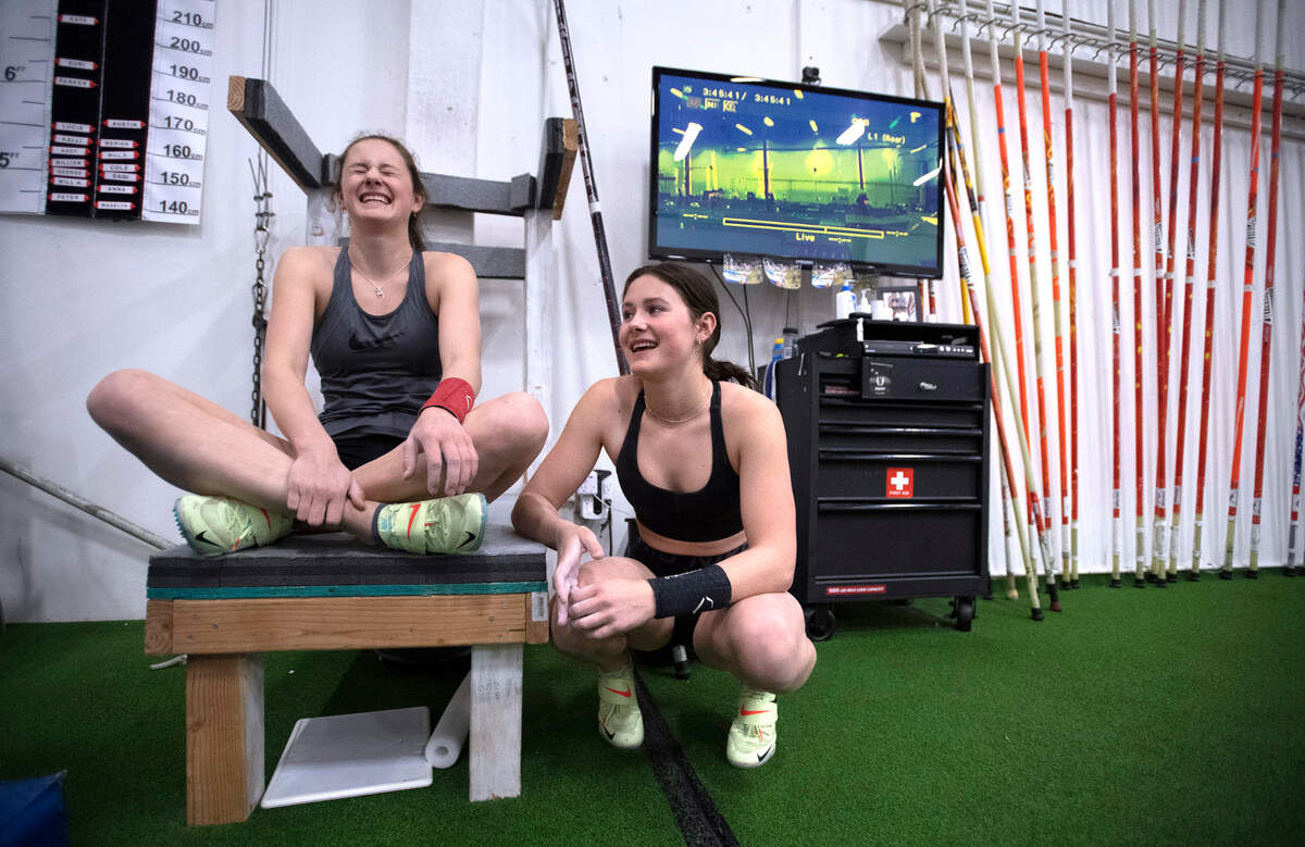 Capital High junior twins Amanda Moll (left) and Hana Moll chat between workouts at coach Tim Reilly’s NW Pole Vault gym in Seattle, Washington, on Tuesday, April 11, 2022.