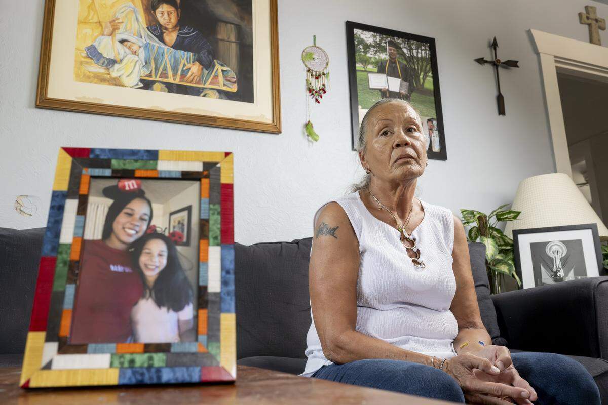 A photo of sisters Ka'Lani Buchanan, left, and Kassidy Buchanan, 14, who has been missing since the fall of 2024, sits in front of their grandmother Joyce Robinson on Tuesday, Aug. 5, 2025, at her home in Tacoma, Wash.