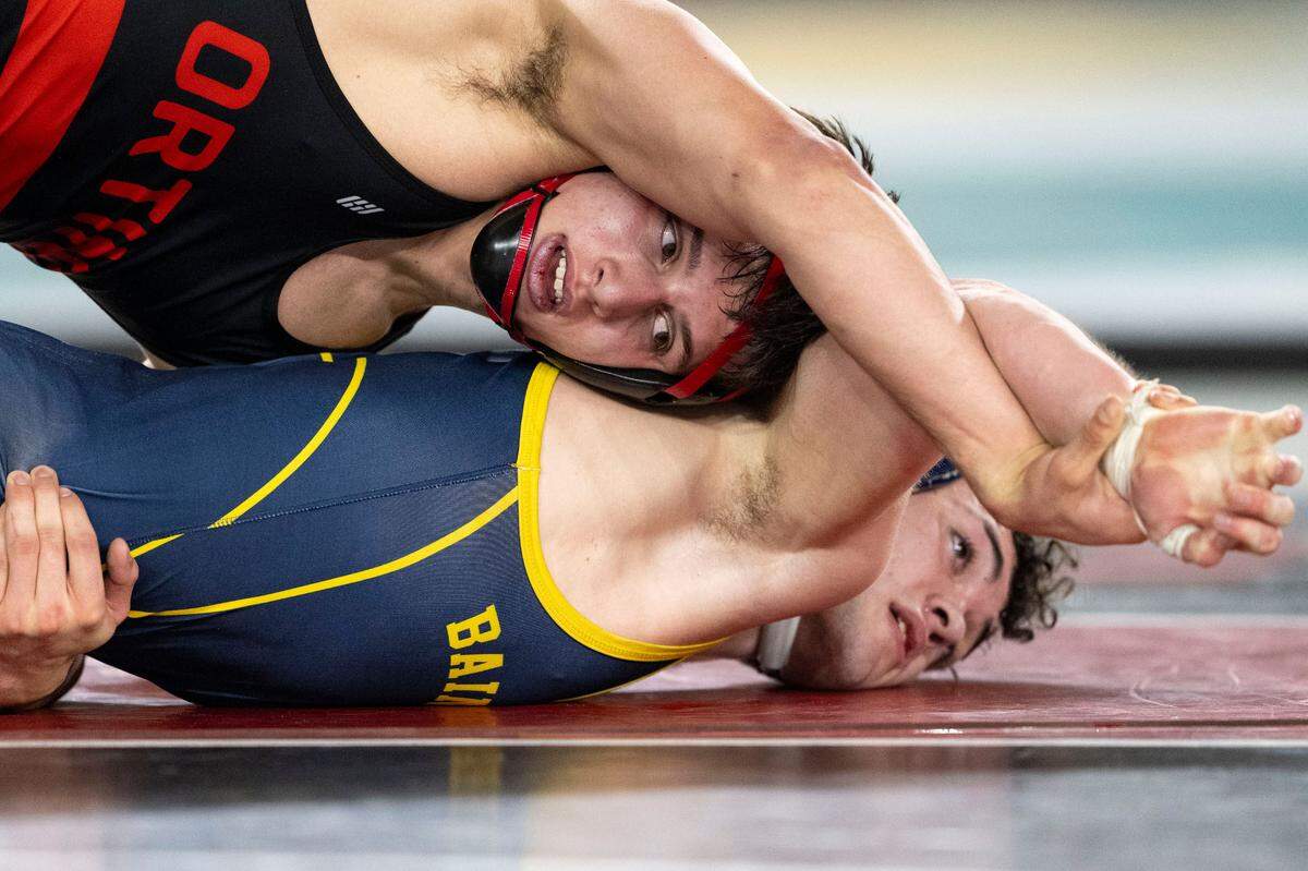 Orting’s Levi DiCugno looks to gain control of the wrist of Bainbridge’s Garrett Goade during their Class 2A 175-pound state championship match on Saturday, Feb. 22, 2025, at Mat Classic XXXVI at the Tacoma Dome in Tacoma, Wash. DiCugno won the match 5-2.