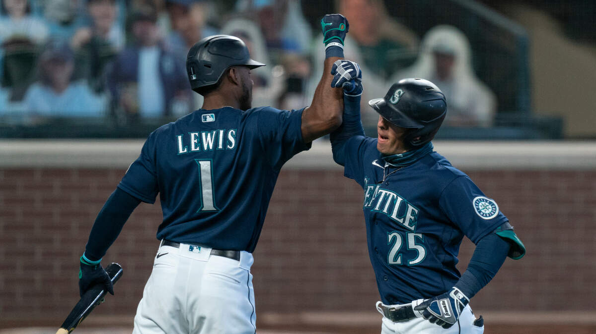 Seattle Mariners’ Dylan Moore, right, is congratulated by teammate Kyle Lewis after hitting a solo home run off of Texas Rangers starting pitcher Kolby Allard during the third inning of a baseball game, Monday, Sept. 7, 2020, in Seattle. (AP Photo/Stephen Brashear)