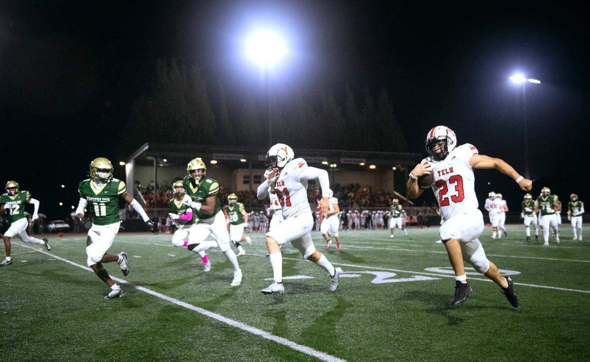 Yelm running back Brayden Platt streaks to a touchdown run behind blocker Chris Hauss (61) during Friday night’s 3A SSC football game against the Timberline Blazers at South Sound Stadium in Lacey, Washington, on Oct. 13, 2023.