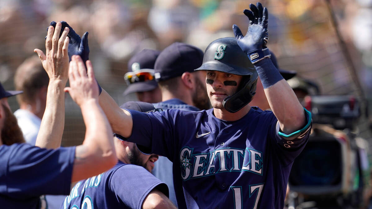 Seattle Mariners’ Mitch Haniger is congratulated by teammates after hitting a home run against the Oakland Athletics during the sixth inning of a baseball game in Oakland, Calif., Thursday, Sept. 23, 2021. (AP Photo/Jeff Chiu)