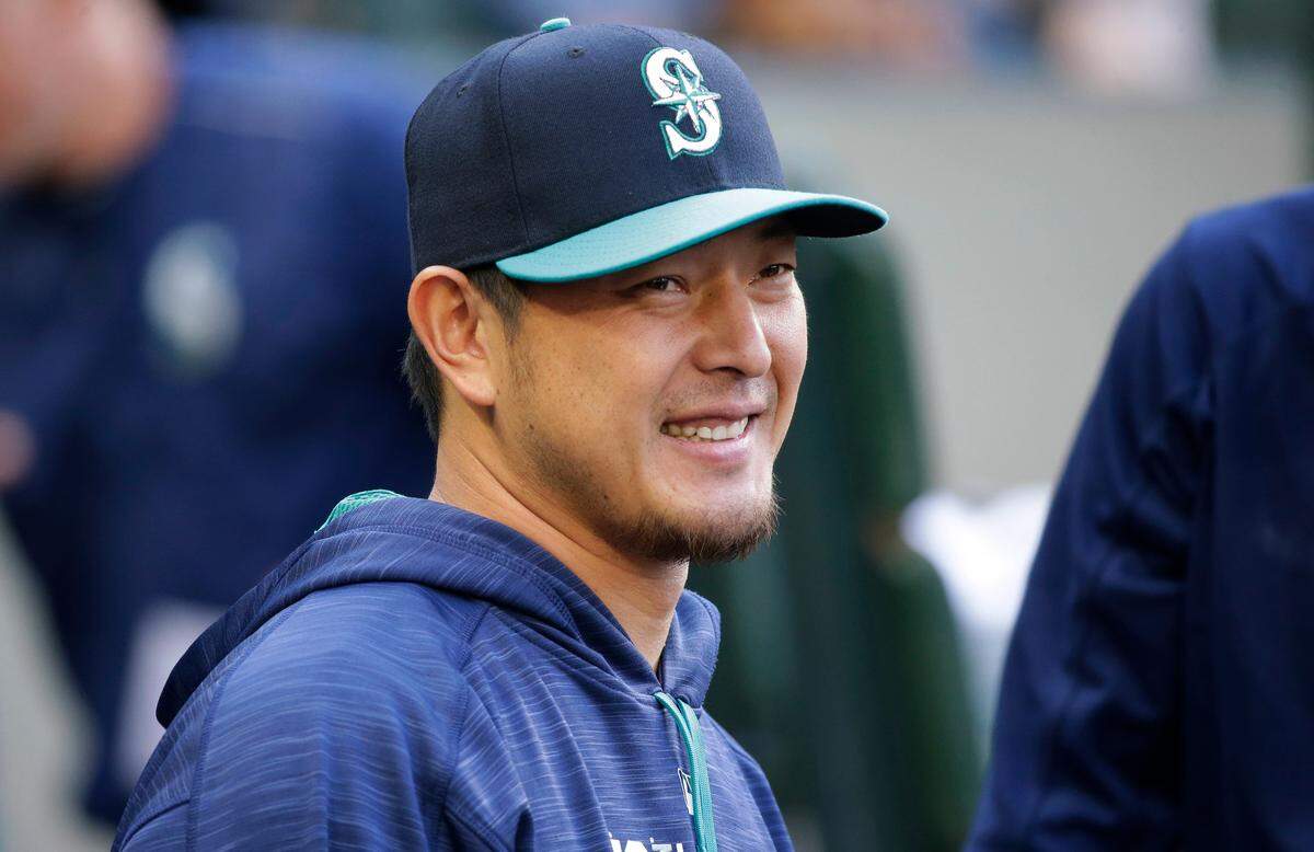 Seattle Mariners pitcher Hisashi Iwakuma smiles as he greets teammates in the dugout before the team’s baseball game against the Oakland Athletics, Friday, July 7, 2017, in Seattle. (AP Photo/Ted S. Warren)