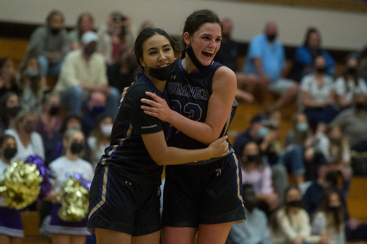 Sumner High School forward Alyson Deaver (33) celebrates with teammate Anuhea Borden following the 4A SPSL girls basketball championship game against Bellarmine Prep on Thursday, June 10, 2021 at Puyallup High School in Puyallup, Wash.