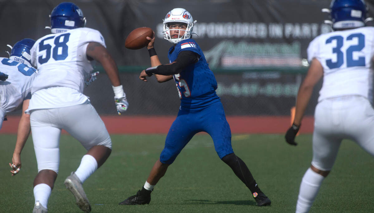 Graham-Kapowsin quarterback Daveon Superales looks to pass downfield under pressure from Curtis defenders (from left) Marquis Watson, Bryce Bouyer and Memphis Robinson during Saturday’s football game at Art Crate Field in Spanaway, Washington, Oct. 8, 2022. Graham-Kapowsin won the game, 24-19.