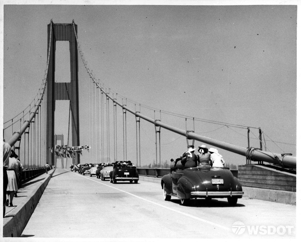This photo shows the grand opening celebration of the Tacoma Narrows Bridge, July 1, 1940. The banner on the bridge tower read: “Scenic Peninsula.”