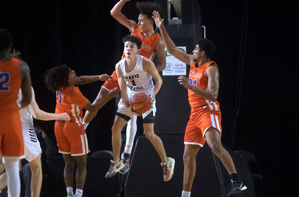 Davis’s Brandon Lee Jr. is swarmed by Graham-Kapowsin defenders (from left) Nicholas Hunter, Joshua Wood and Avery Isler during Wednesday afternoon’s opening-round game of the WIAA 4A Boys Basketball State Championships tournament in the Tacoma Dome in Tacoma, Washington, on Wednesday, March 2, 2022.