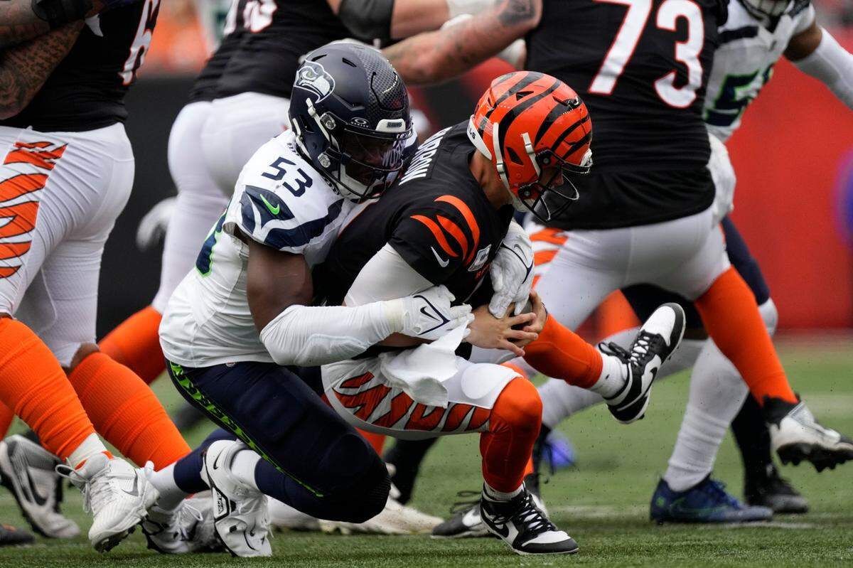 Cincinnati Bengals quarterback Joe Burrow (9) is sacked by Seattle Seahawks’ Boye Mafe (53) during the second half of an NFL football game, Sunday, Oct. 15, 2023, in Cincinnati. (AP Photo/Carolyn Kaster)