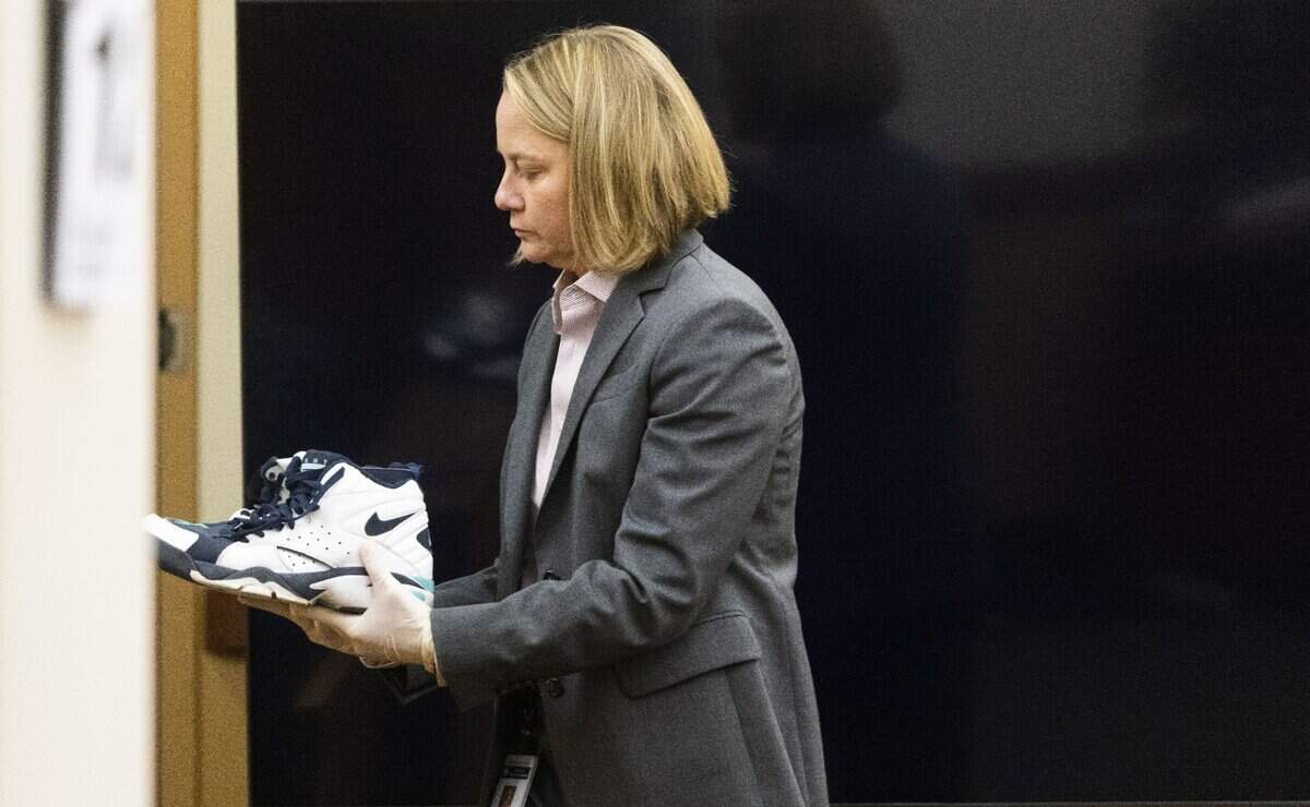 State assistant attorney general Lori Nicolavo shows the jury the shoes that Manny Ellis was wearing at the time of his death.