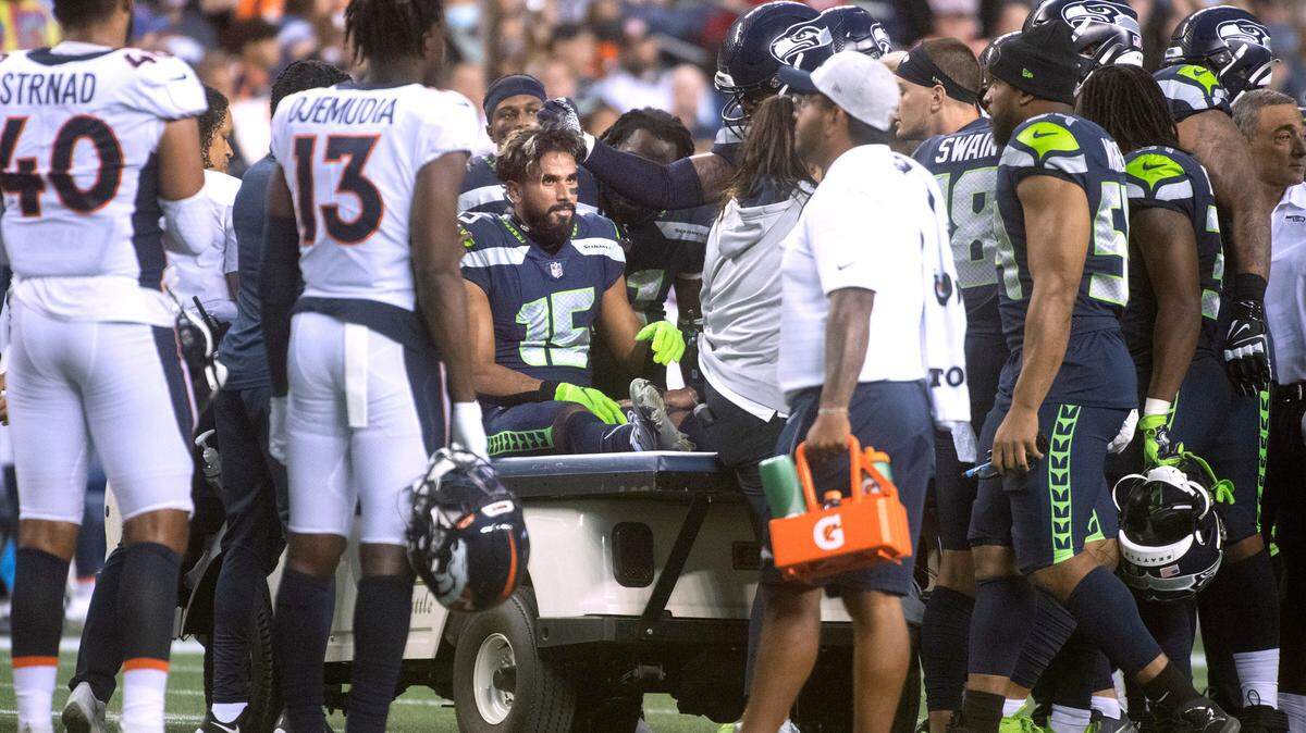 Seahawks wide receiver John Ursua is taken off the field on a cart after getting injured during Saturday night’s NFL preseason football game against the Denver Broncos at Lumen Field in Seattle, Washington, on Saturday, Aug. 21, 2021.