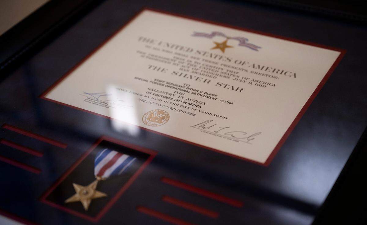 The Silver Star for Special Forces Medical Sergeant Bryan Black sits on the table for guest to take photos of during a Silver Star Award Ceremony at Pioneer Park Pavillion, on Tuesday, April 8, 2025, in Puyallup, Wash.