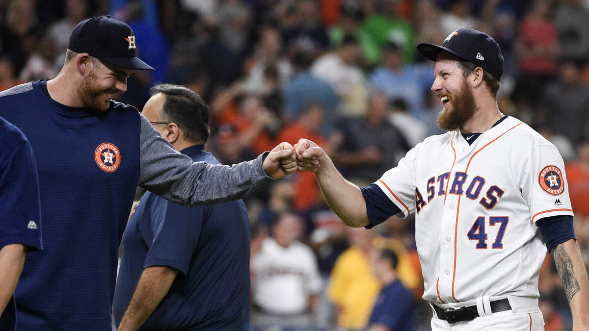 Houston Astros relief pitcher Chris Devenski, right, celebrates with Joe Biagini, who had pitched the eighth inning, the team’s win and four-pitcher combined no-hitter in a 9-0 win over the Seattle Mariners in a baseball game, Saturday, Aug. 3, 2019, in Houston.