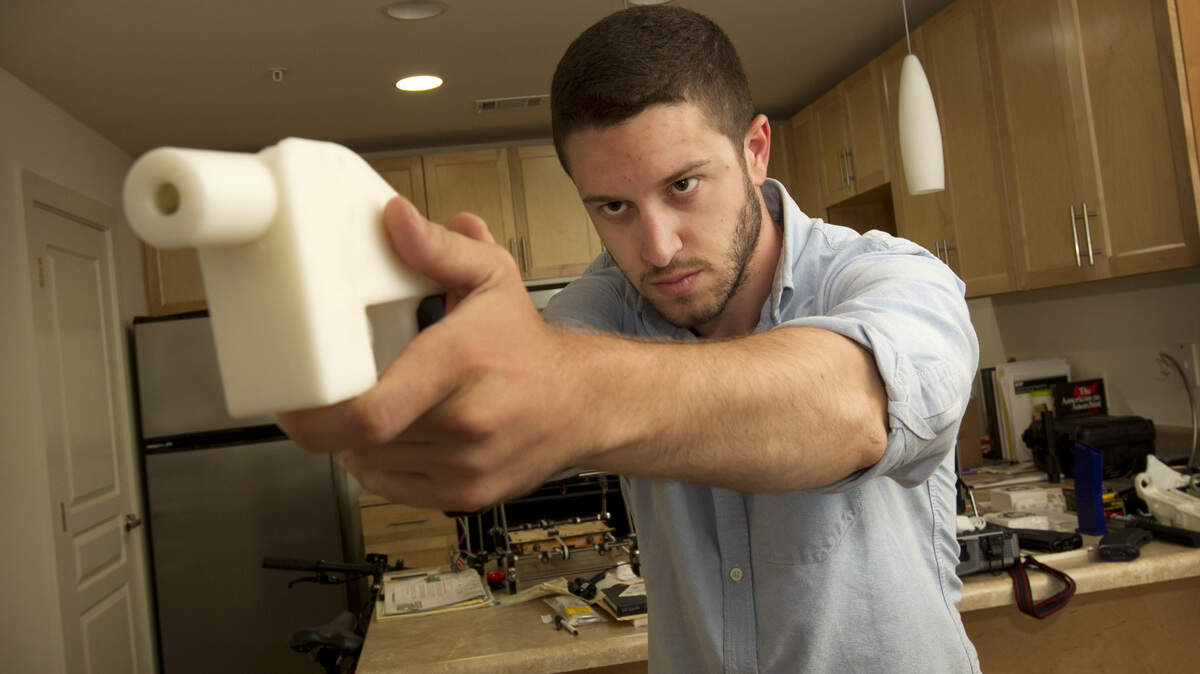 Cody Wilson shows the first completely 3D-printed handgun, The Liberator, at his home in Austin, Texas.
