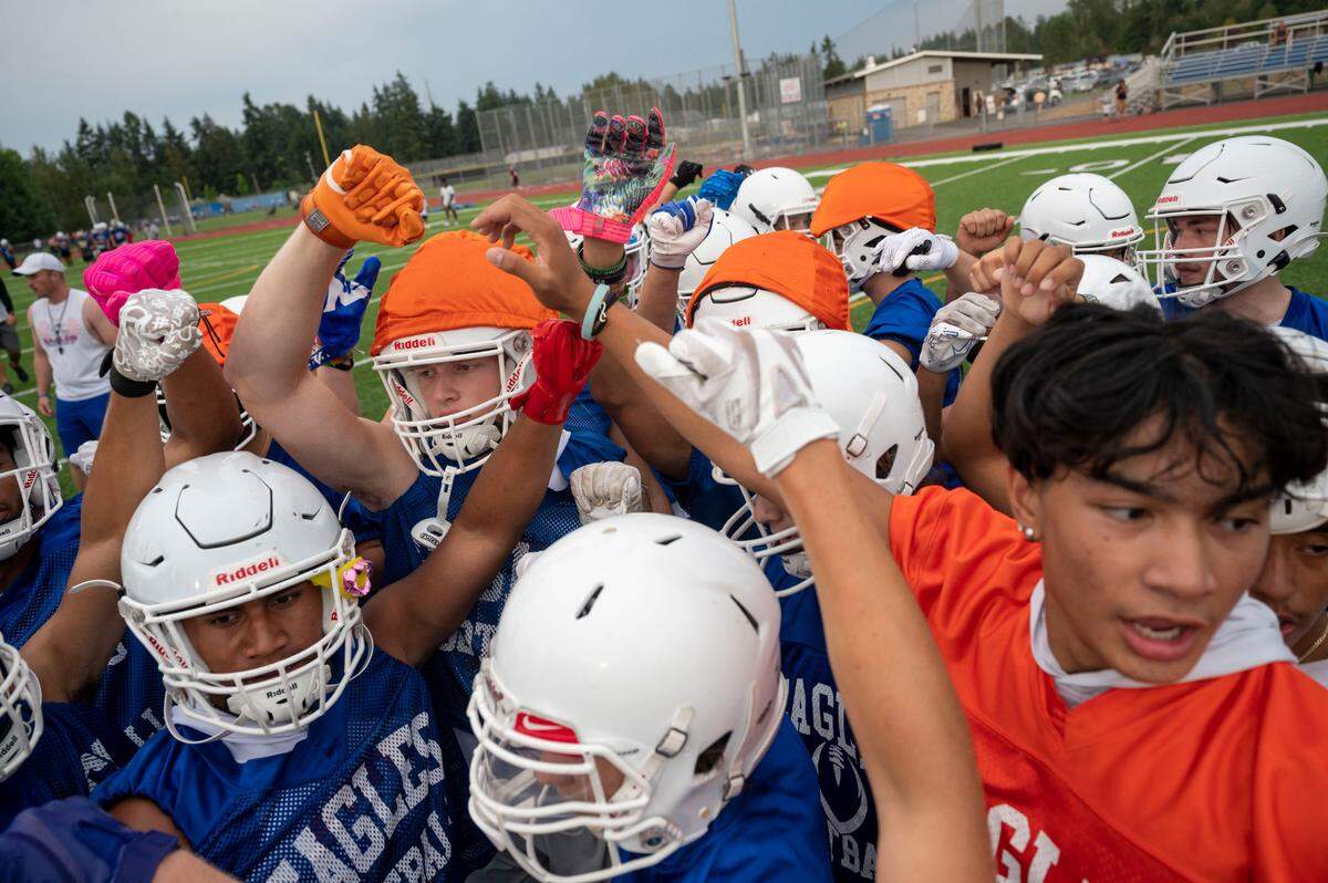 About 150 students came out for the first week of practice for the State 4A defending champion Eagles as they prepare to take a water break on Thursday, Aug. 18, 2022, at Graham Kapowsin High School, in Graham, Wash.
