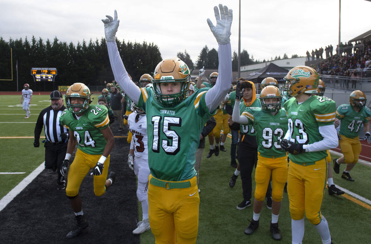 Tumwater’s TeJay Parker (left) and Ashton Paine (15) celebrate Turner Allen’s punt return for a touchdown during Saturday’s 2A state quarterfinal football game against Archbishop Murphy at Tumwater District Stadium on Nov. 23, 2019.