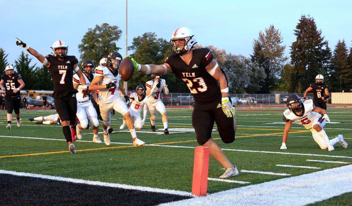 Yelm running back Brayden Platt stretches the ball over the goal line for a touchdown in front of teammate Marius Aalona during Friday night’s season-opening football game against the Camas Papermakers at Yelm High School in Yelm, Washington on Friday, Sept. 2, 2022.