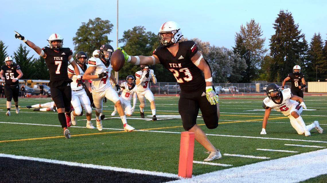 Yelm running back Brayden Platt stretches the ball over the goal line for a touchdown in front of teammate Marius Aalona during Friday night’s season-opening football game against the Camas Papermakers at Yelm High School in Yelm, Washington on Friday, Sept. 2, 2022.