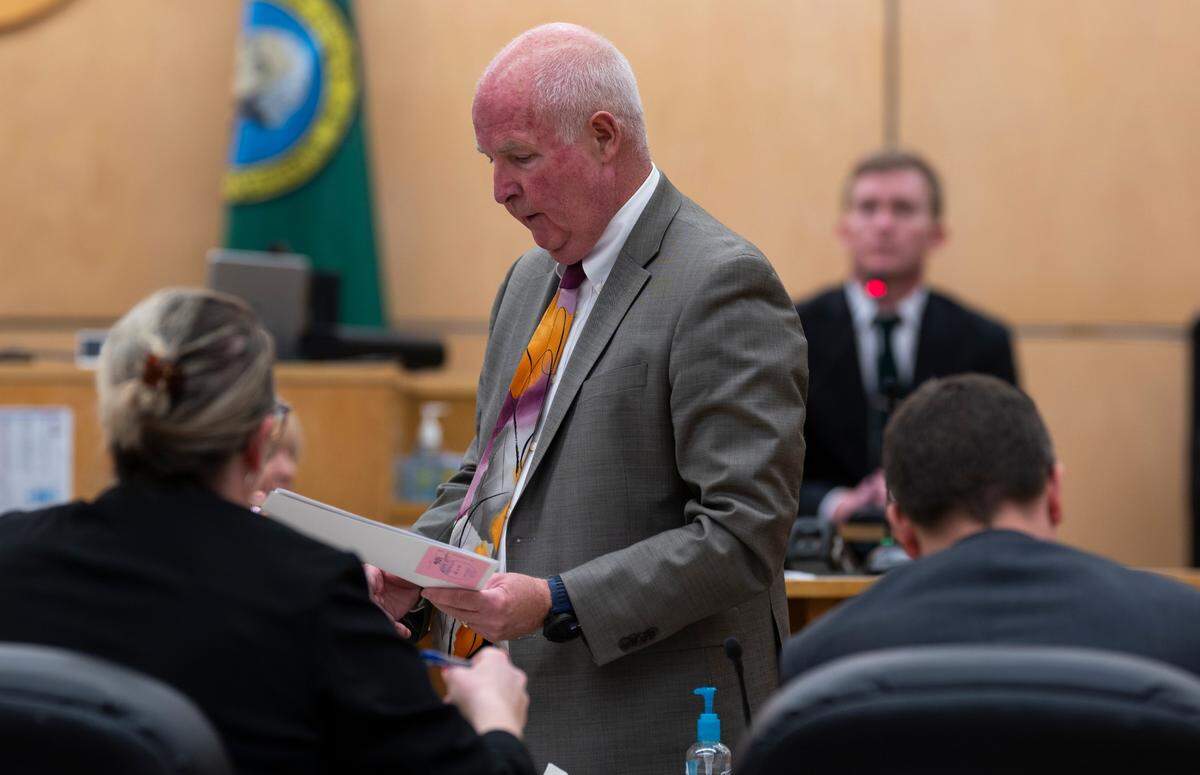 Defense attorney Brett Purtzer shows documents to prosecutors before publishing during the trail of Jacob “Jake” Jackson, former Sumner High School coach, for sexual abuse of his players, at Pierce County Superior Court, on Wednesday, Jan. 22, 2025, in Tacoma Wash.