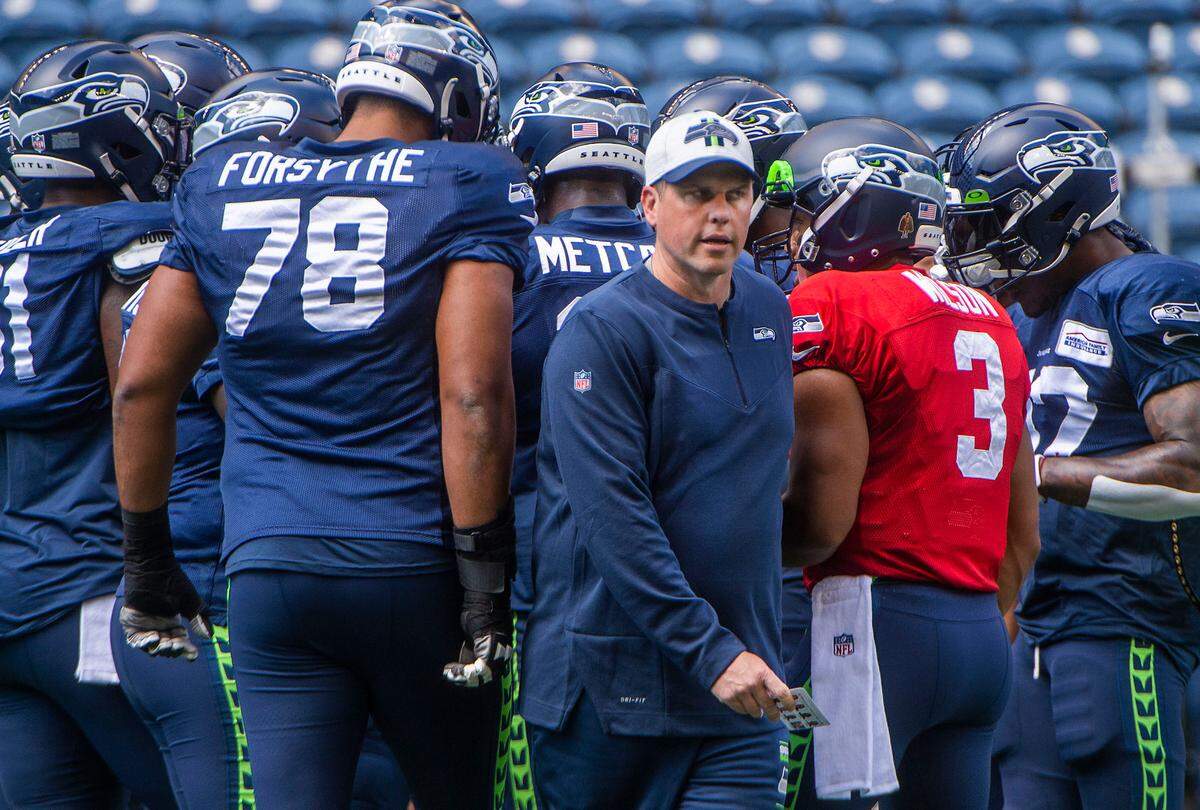 New Seahawks offensive coordinator Shane Waldron emerges from a huddle prior to the annual training camp mock game at Lumen Field in Seattle on August, 5, 2021.