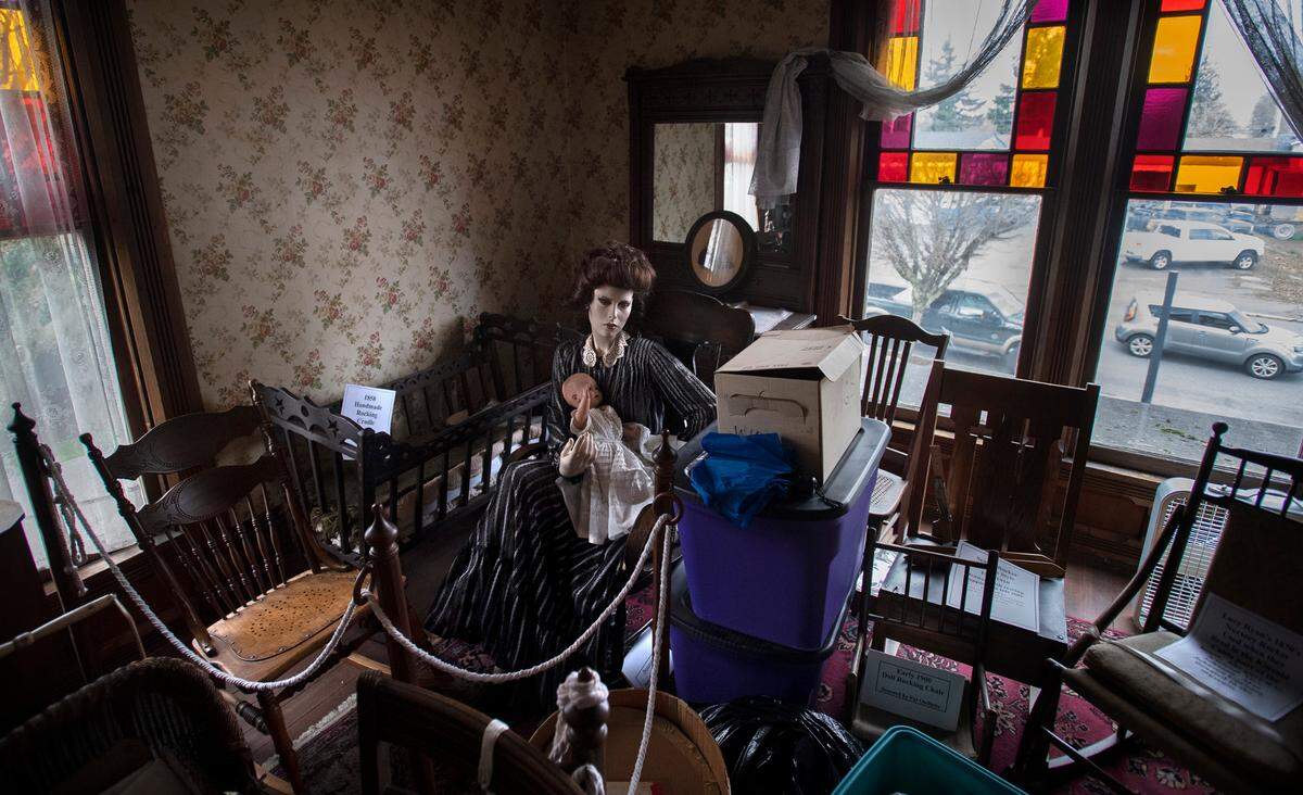 A pair of spooky mannequins sit in an upstairs bedroom inside the Sumner Ryan House Museum at Lucy V. Ryan Park in downtown Sumner, Washington, on Wednesday, Feb. 16, 2022.