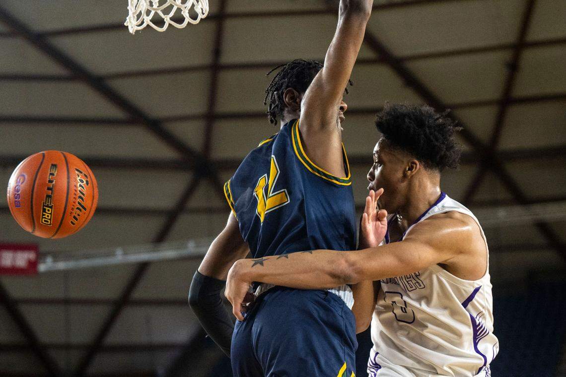 Garfield guard Myles Daymon (0) tosses a pass around the back of Shorecrest forward Disma Kagarabi (12) during the second quarter of a Class 3A quarterfinal game on Thursday, March 2, 2023, in Tacoma, Wash.