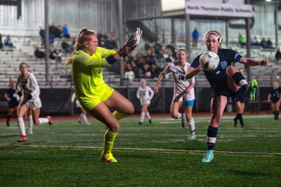 Gig Harbor forward Alexa Thoms attempts to volley the ball past Auburn Riverside keeper Rory Murry during the second half of the District 3/4 girls soccer championship game on Thursday night at South Sound Stadium in Lacey.