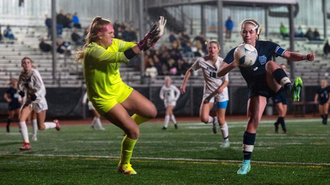 Gig Harbor forward Alexa Thoms attempts to volley the ball past Auburn Riverside keeper Rory Murry during the second half of the District 3/4 girls soccer championship game on Thursday night at South Sound Stadium in Lacey.