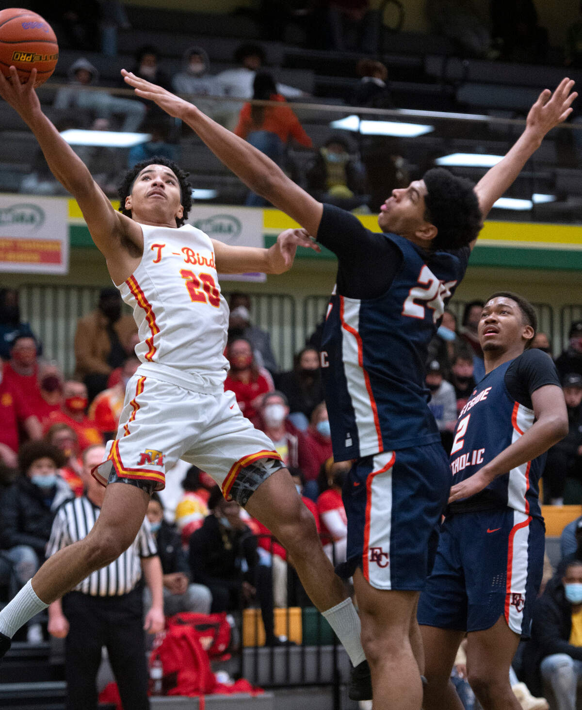 Mount Tahoma’s Asjon Johnson flies to the basket against Eastside Catholic defender Jacob Cofie during Friday night’s boys basketball regional playoff game at Foss High School Tacoma, Washington, on Feb. 25, 2022. Eastside Christian won the game, 68-51.