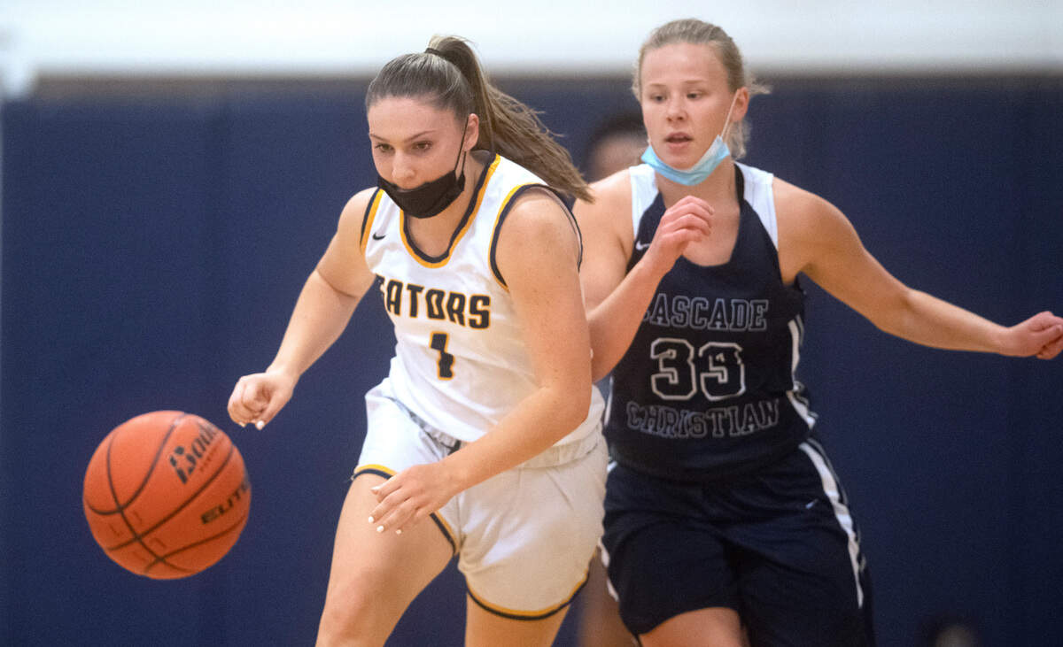 Annie Wright senior Julianna Walker steals the ball from Cascade Christian’s Emily Patrick during the Gators’ 82-35 victory over the Cougars in the 1A Nisqually league’s title game at Annie Wright High School in Tacoma, Washington, on Friday, June 18, 2021. Walker scored 28 points in the win.
