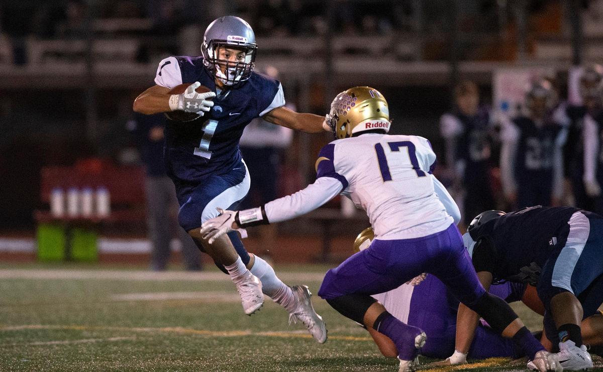 River Ridge running back Michael Paje fights off Highline linebacker Daniel Voung during Friday night’s 2A SPSL crossover football game at South Sound Stadium in Lacey on Nov. 1, 2019.