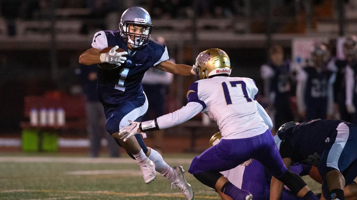 River Ridge running back Michael Paje fights off Highline linebacker Daniel Voung during Friday night’s 2A SPSL crossover football game at South Sound Stadium in Lacey on Nov. 1, 2019.