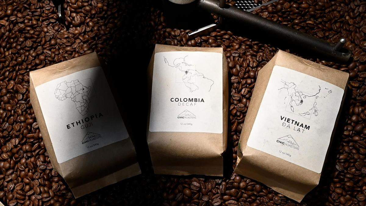 Bags of Civic Roasters’ coffee lie in a pile of beans as they are cooled down after being roasted by Civic Roasters co-owners Benita Ki and Kyle Bradshaw at Roasterworks on Tuesday, April 26, 2022 in Auburn, Wash.