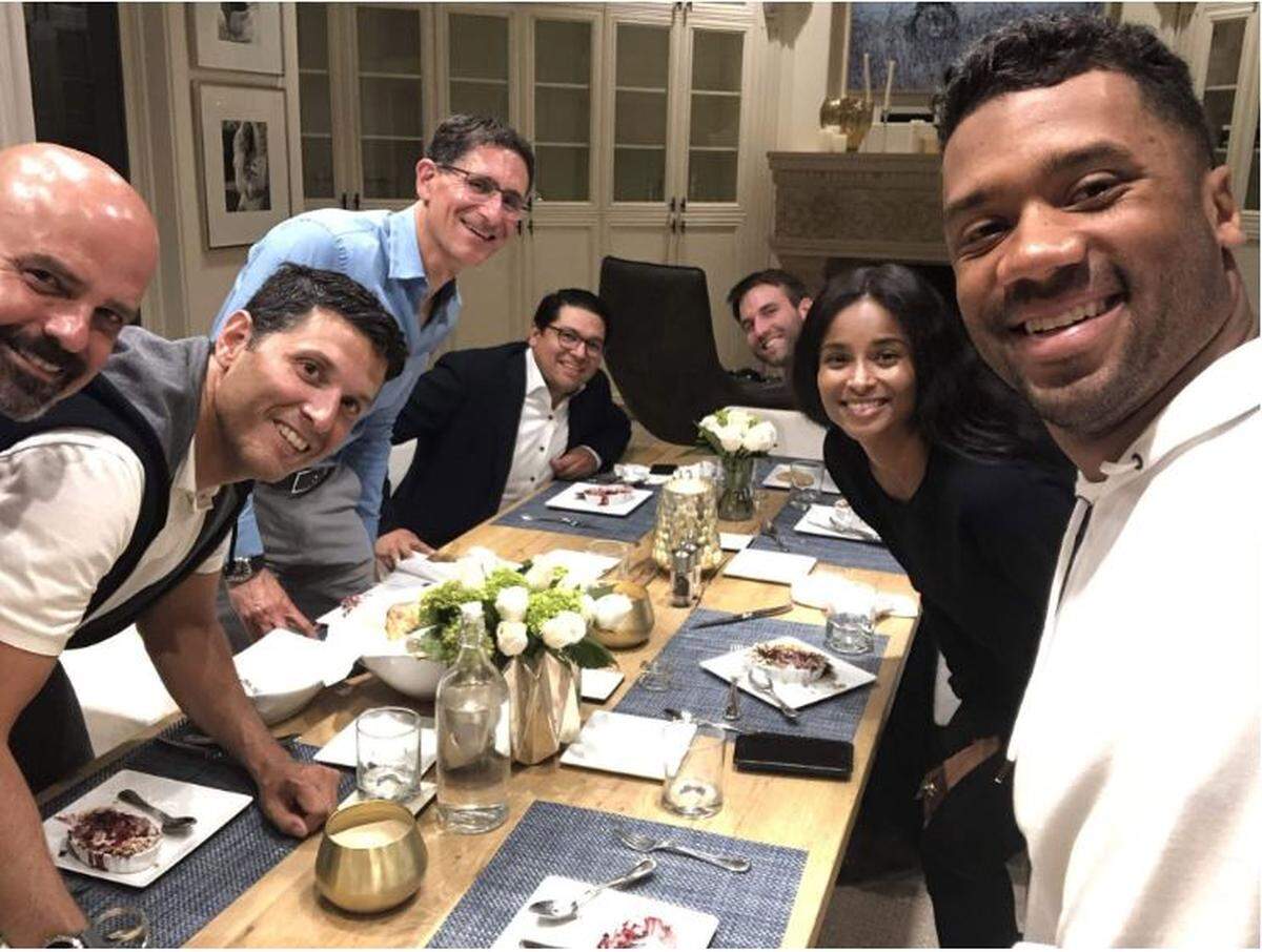 Seahawks quarterback Russell Wilson (far right) and his wife Ciara (to his left) host dinner at their house in Bellevue last fall for a group that would eventually join them this summer in becoming new part owners of the Seattle Sounders Major League Soccer team.