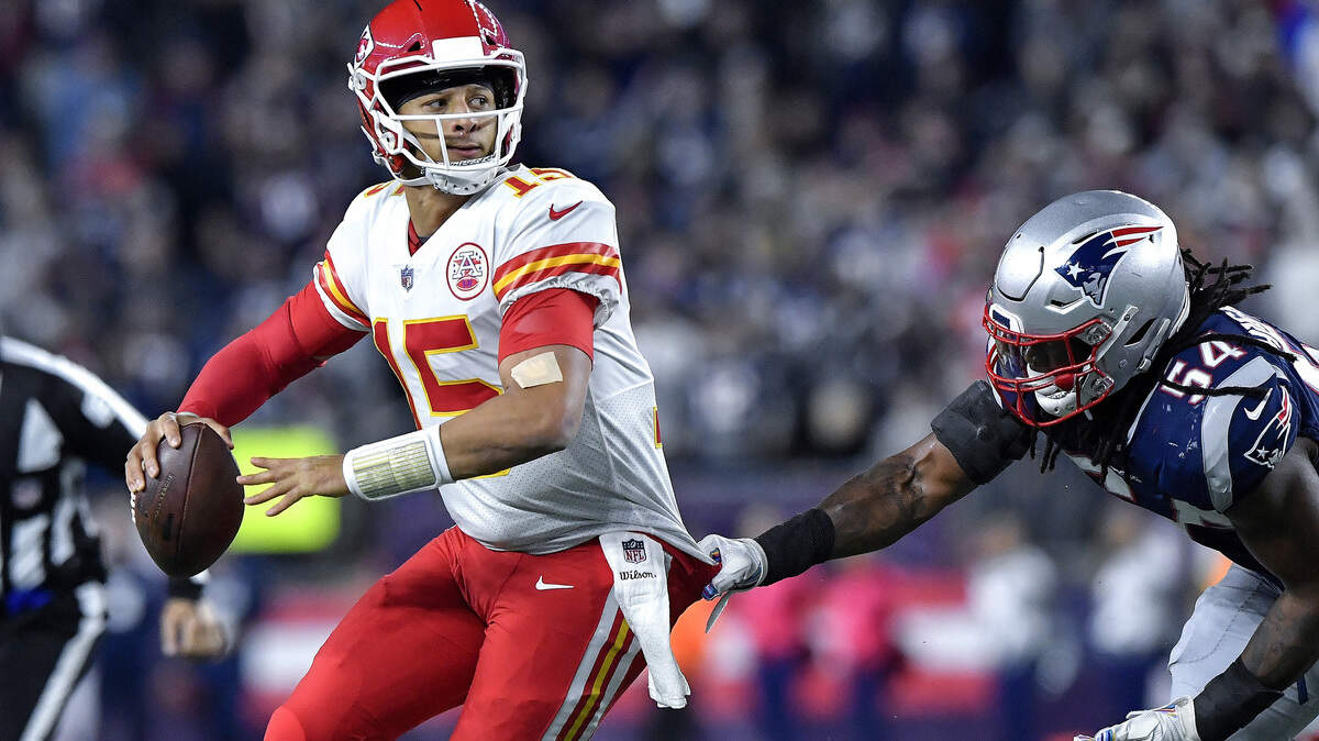 Kansas City Chiefs quarterback Patrick Mahomes throws an interception in the end zone under pressure from New England Patriots linebacker Dont’a Hightower in the closing seconds of the second quarter on Sunday, Oct. 14, 2018 at Gillette Stadium in Foxborough, Mass. (John Sleezer/Kansas City Star/TNS)