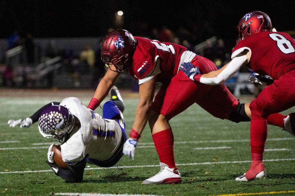 Kennedy Catholic’s Micah Banuelos throws Lake Stevens running back Jayden Limar to the ground in the backfield for a loss during the third quarter of the Class 4A state championship game on Saturday, Dec. 3, 2022, at Mount Tahoma High School in Tacoma, Wash.