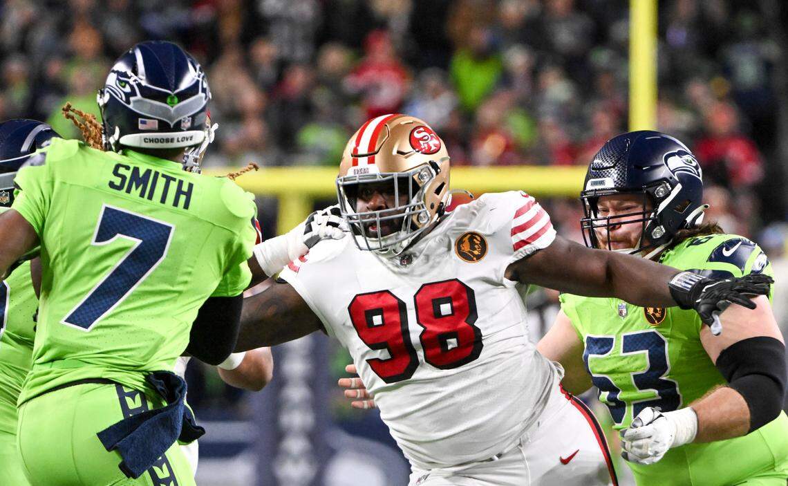 San Francisco 49ers defensive tackle Javon Hargrave (98) pressure Seattle Seahawks quarterback Geno Smith (7) during the second quarter of the game at Lumen Field, Thursday, Nov. 23, 2023, in Seattle, Wash.