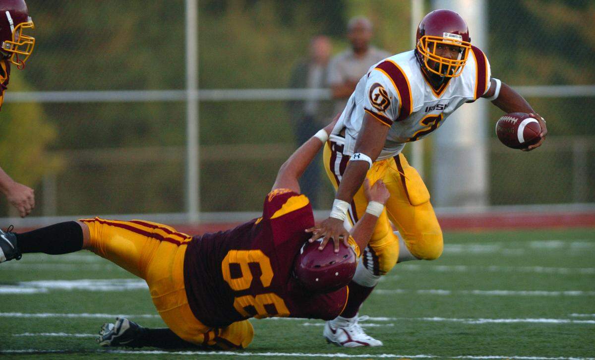 Capital defender Tyler Camus (68) comes up short on a sack attempt of O’Dea quarterback Taylor Mays. (Tony Overman/The Olympian)