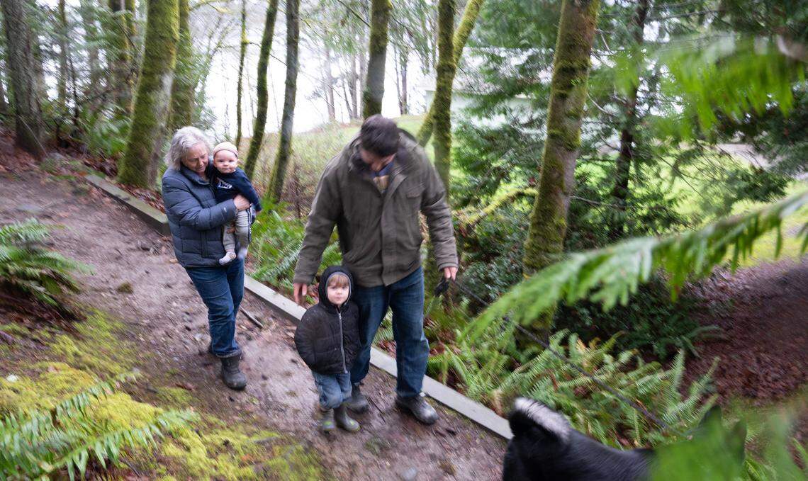 A family arrives for a walk at DeMolay Sandspit Park on Fox Island, Washington, on Wednesday, Feb. 21, 2024. PenMet Parks has plans for improvements to the park that some in the area worry could lead to a decline in wildlife that thrives in the woods, beach and sandspit.