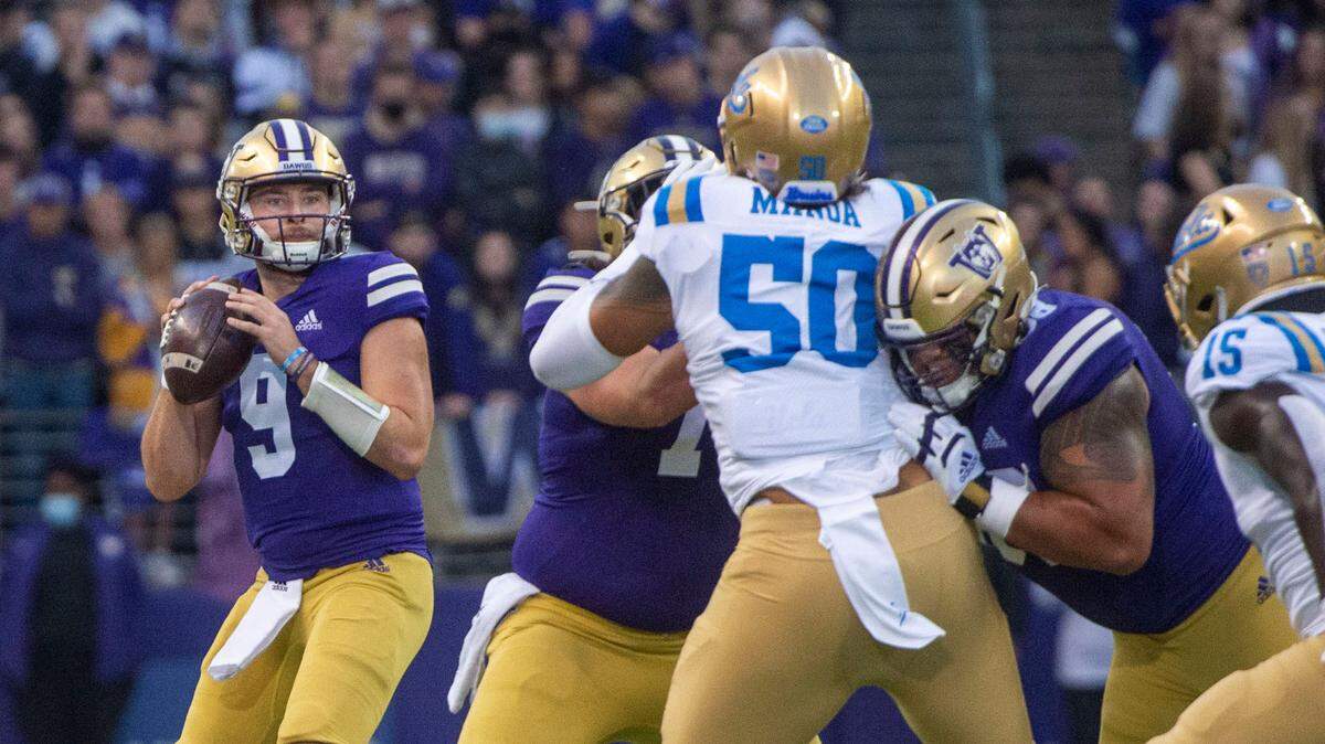 Huskies quarterback Dylan Morris throws under pressure during an NCAA college football game between Washington and UCLA Saturday, Oct. 16, 2021, in Seattle.