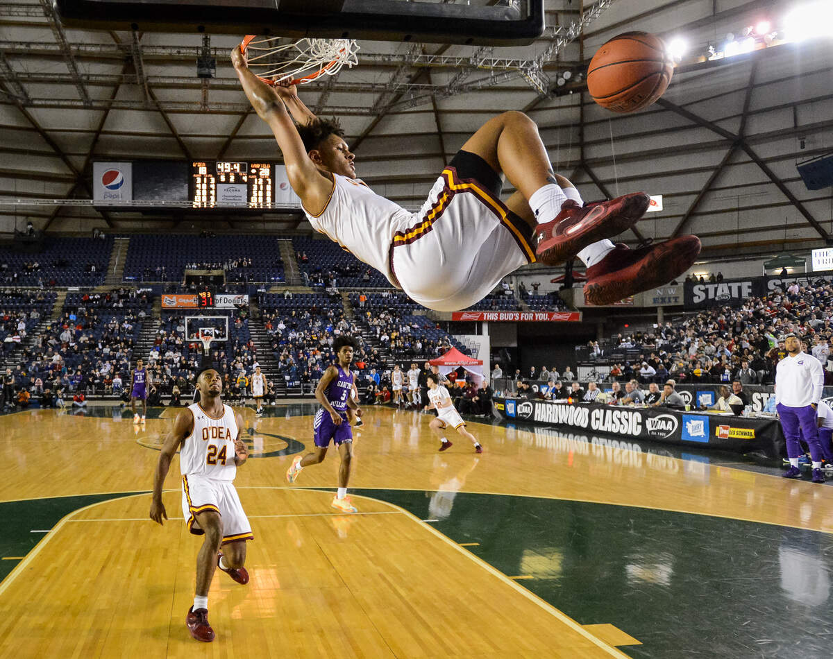 O’Dea’s Paolo Banchero hangs on the rim after a dunk during the second quarter. Garfield played O’Dea in the 3A boys championship game at the Hardwood Classic state basketball tournament at the Tacoma Dome in Tacoma, Wash., on Saturday, March 7, 2020.