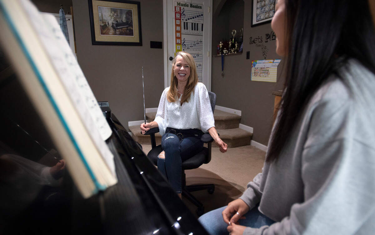 Kimberley Joe works with Bellarmine Prep senior Mia Filand, 17, in the piano studio at her home in Gig Harbor, Washington, on Friday, March 11, 2022. “My mother was a piano teacher and taught kids in the harbor. My dad owned Walt’s Piano Place and was a piano tuner,” she explained. “I was destined to become a piano teacher, because I was good at it.”