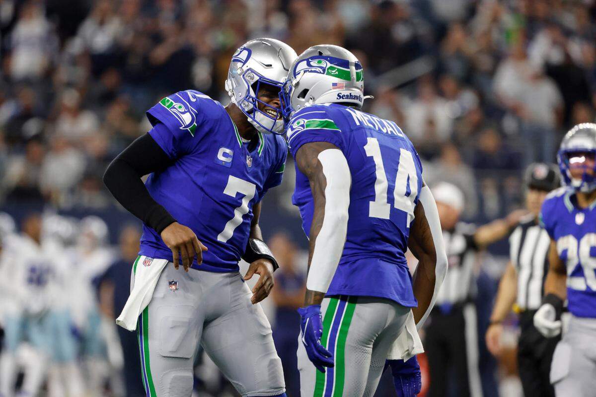 Seattle Seahawks quarterback Geno Smith (7) and wide receiver DK Metcalf (14) celebrate afer Metcalf caught a touchdown pass late in the first half of an NFL football game against the Dallas Cowboys in Arlington, Texas, Thursday, Nov. 30, 2023. (AP Photo/Michael Ainsworth)