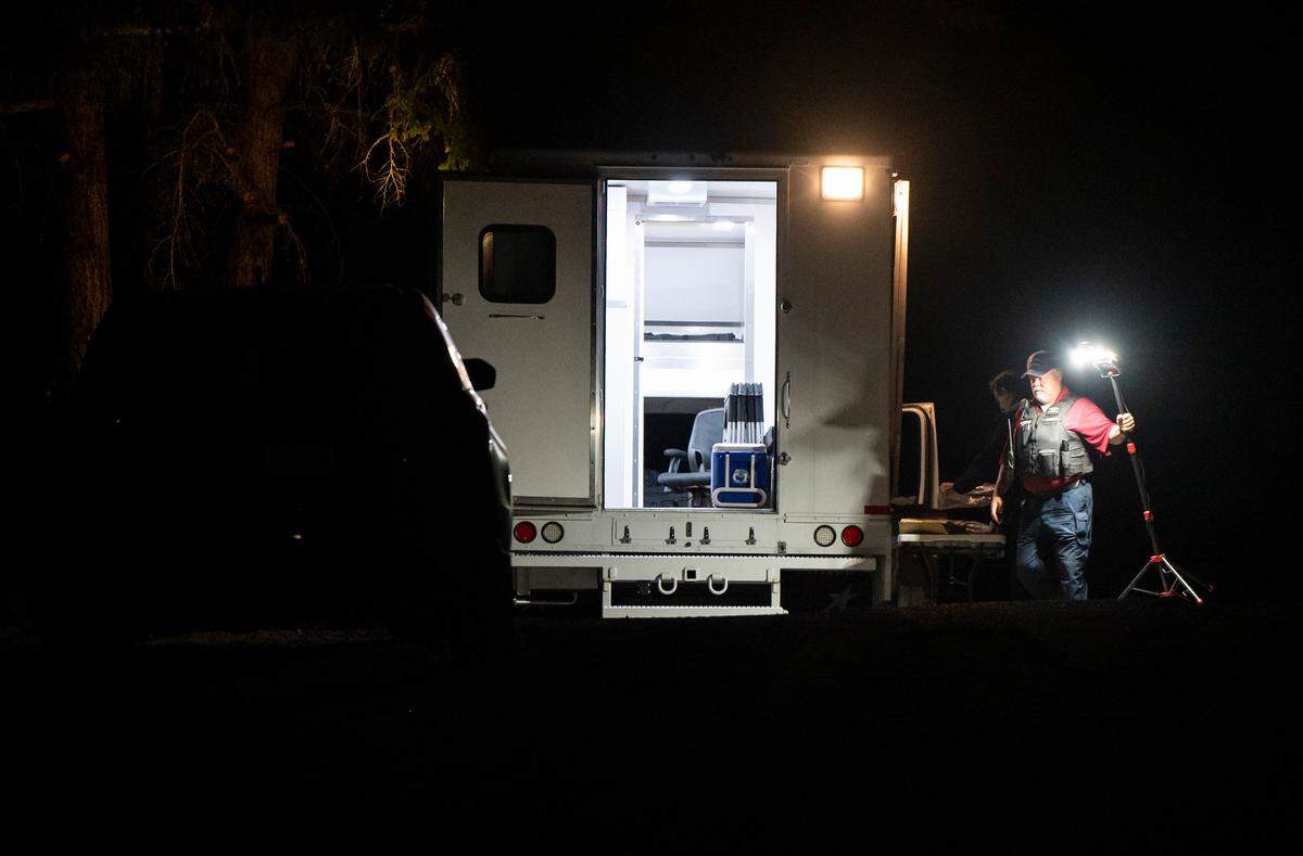 Crime scene technicians investigate a homicide scene where neighbors reported that “someone shooting a gun was chasing another man,” and officers found a man deceased in a neighbor’s home after he was reported to be banging on the neighbors window, at the 25600 block of 61st Avenue Court East in Graham, Wash. on Sept. 25, 2022.
